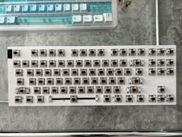 A NZXT Function Keyboard without keycaps and custom drop ones near it